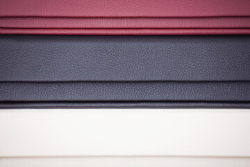 stack of photoook boxes. Wedding boxes of photobook in white, red and black leather binding. cover...