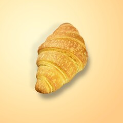 Freshly baked tasty sweet croissant on desk