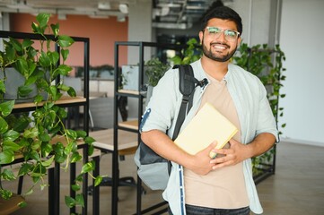 Happy indian male student at the university