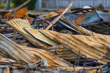 pile of twisted rusted metal debris from collapsed structure.