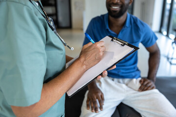 African american young man having an appointment with a doctor in rehabilitation center