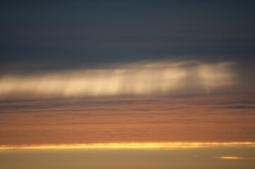 Light shining through clouds in early summer evening