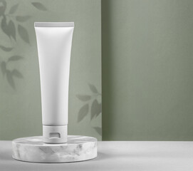 Blank white tube of skincare products arranged on a beautifully elegant surface