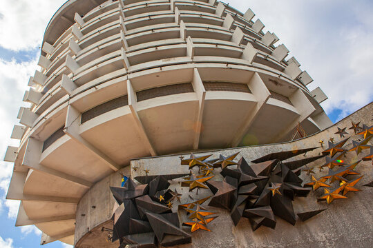 Kyiv, Ukraine - April 22, 2024: Hotel Salute, built in 1984, a notable example of Soviet-era modernist architecture, against a blue sky. Known for its cylindrical design and historical significance..