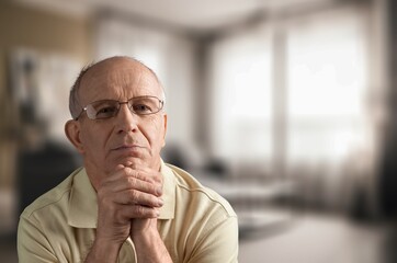 Thinking old senior man posing in home