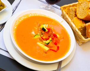 Delicious Spanish cold soup Gazpacho from raw blended vegetables garnished with diced ingredients