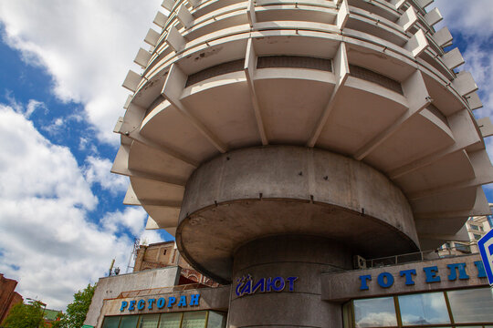 Kyiv, Ukraine - April 22, 2024: Hotel Salute, built in 1984, a notable example of Soviet-era modernist architecture, against a blue sky. Known for its cylindrical design and historical significance..