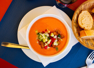 Image of spanish traditional cold soup gazpacho in bowl with tomatoes and cucumber..