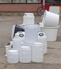 Various Size and Shape of White Plastic Drums and Barrels Gallon Containers With Lids