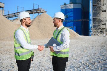 Two engineers at a stone crushing plant. The concept of quarrying.