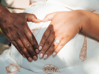 hands of two expecting parents