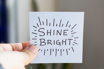 Sticky Notes with 'Shine Bright' on Colored Paper