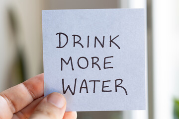 Sticky Notes with 'Drink More Water' on Colored Paper