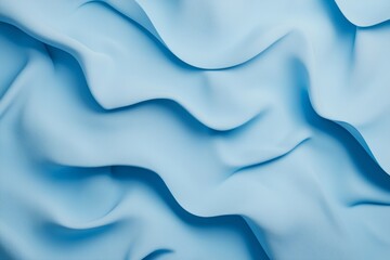 Fototapeta premium Light blue fabric flowing smoothly creating soft waves, perfect for backgrounds and textures, representing elegance, fluidity, and delicate movements