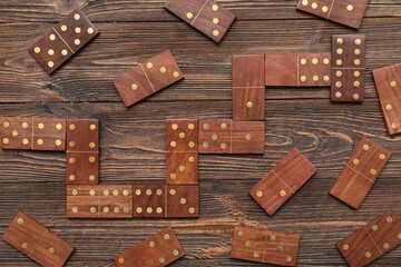 Many dominos blocks on wooden background