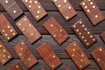 Many dominos blocks on dark wooden background