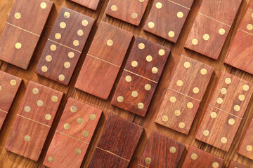 Many dominos blocks on wooden background