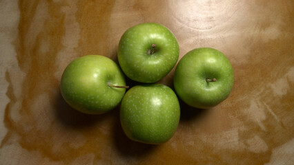 Close-up of group of Gala apples on a wooden table
