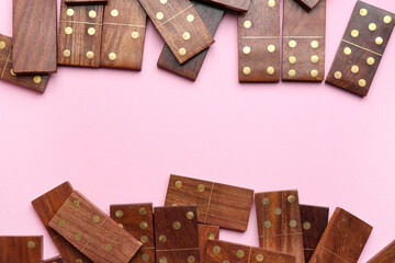 Many wooden dominos blocks on pink background