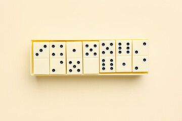 Container with white dominos blocks on light background