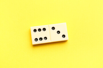White domino block on yellow background