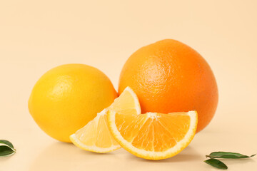 Cut oranges and leaves on beige background