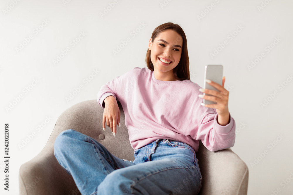 Poster cheerful caucasian woman using smartphone, chatting on web, working or studying online, sitting in a