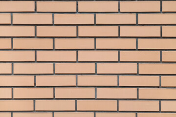 Texture of beige brick wall as background, closeup