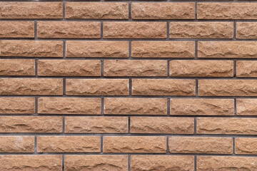 Texture of beige brick wall as background, closeup