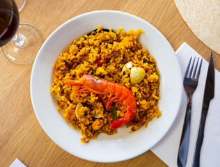 Appetizing racy seafood paella with mussels and prawns.Traditional Valencian cuisine