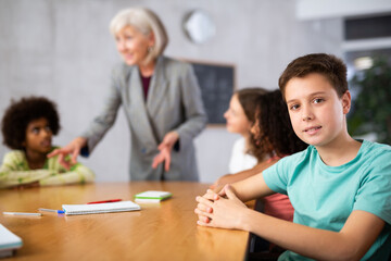 Kids sitting patiently in classroom learing new things