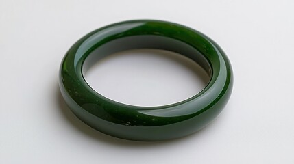 Green jade bangle on white background, jewelry studio shot