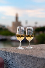 Sherry wine tasting on roof of old Triana district in Sevilla with view on Sevilla houses and river, wine glasses