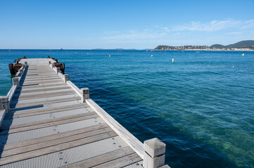 Obraz premium Morning view on crystal clear blue water of Plage du Debarquement white sandy beach near Cavalaire-sur-Mer and La Croix-Valmer, summer vacation on French Riviera, Var, France
