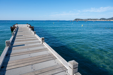 Fototapeta premium Morning view on crystal clear blue water of Plage du Debarquement white sandy beach near Cavalaire-sur-Mer and La Croix-Valmer, summer vacation on French Riviera, Var, France