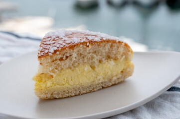 Cake of French Riviera, Tarte Tropezienne cake in yacht harbour of Port Grimaud, summer vacation in Provence, France