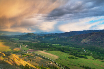 Naklejka premium Storm clouds glowing from setting sun over Methow Valley, North Cascades, Washington State
