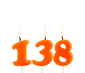 Lit birthday candle - Candle number 138 on white background.