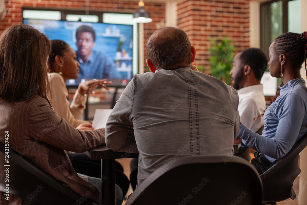 Poster rearview of entrepreneurs engaged in virtual meeting, brainstorming strategy ideas and using monitor