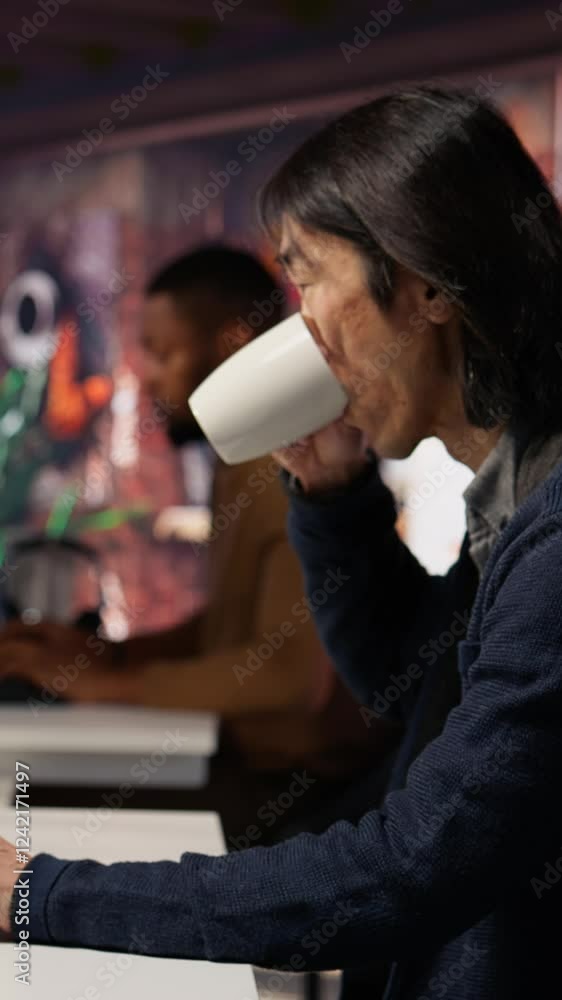Fototapete vertical video software engineer in small business workspace using computer to oversee artificial in