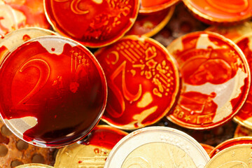 Bloody criminal money.Symbol of dirty money. Euro coins in blood.Payment for contract killing concept 