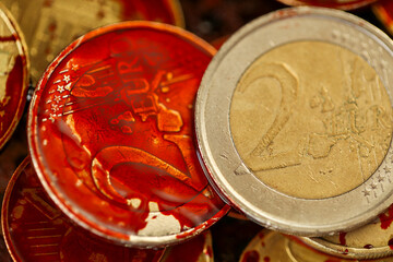 blood on coins close up. blood and shiny euro money.Symbol of dirty money.Bloody criminal finance. Euro coins in blood.Payment for contract killing concept 