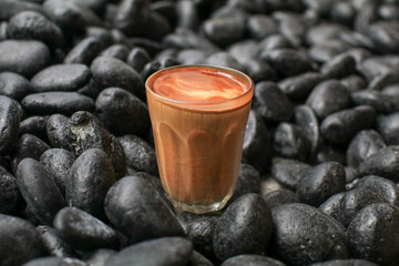 Hot latte coffee on black rock floor. Breakfast beverage morning concept. Coffee shop at the cafe.