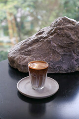Hot latte coffee on table. Breakfast beverage morning with natural background. Coffee shop at the cafe.