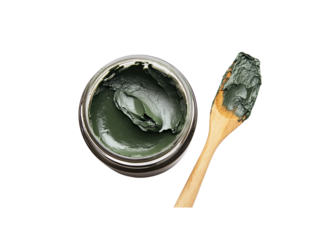A jar of dark green paste with a wooden spatula, Isolated on white background.