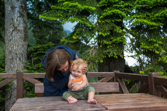 the father covered the baby's ears while playing.