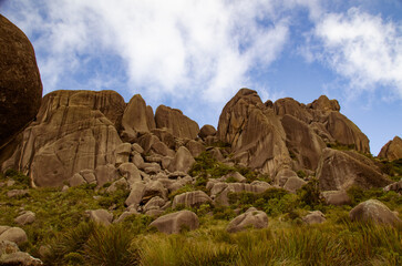 Rocky landscape with rugged cliffs under a bright blue sky.