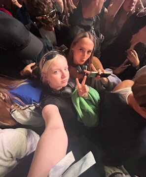 UGC wide angle selfie of two teenagers in a crowd at a music festival.