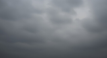 Fototapeta premium Overcast sky with thick, uniform gray clouds creating a moody, diffused lighting effect