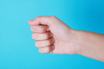 Woman with visible hand veins on light blue background, closeup